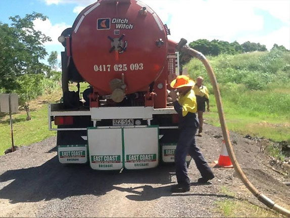 Workers using a vac truck on a worksite in Rockhampton