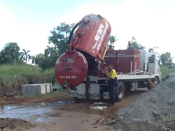 A man emptying a vacuum truck carriage on site in Rockhampton