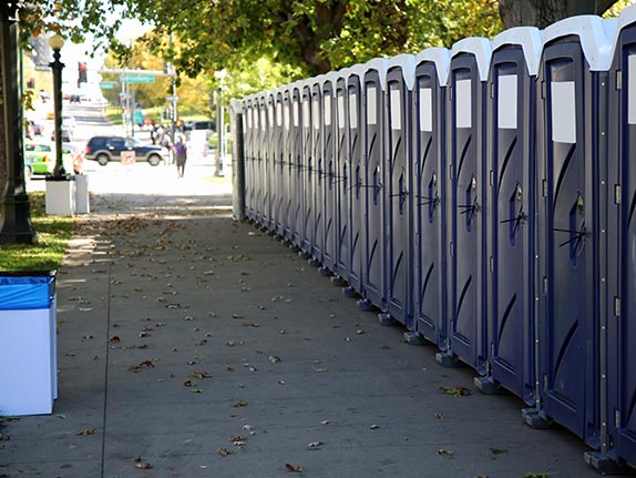 A large row of portable toilets lined up for a park event in Rockhampton